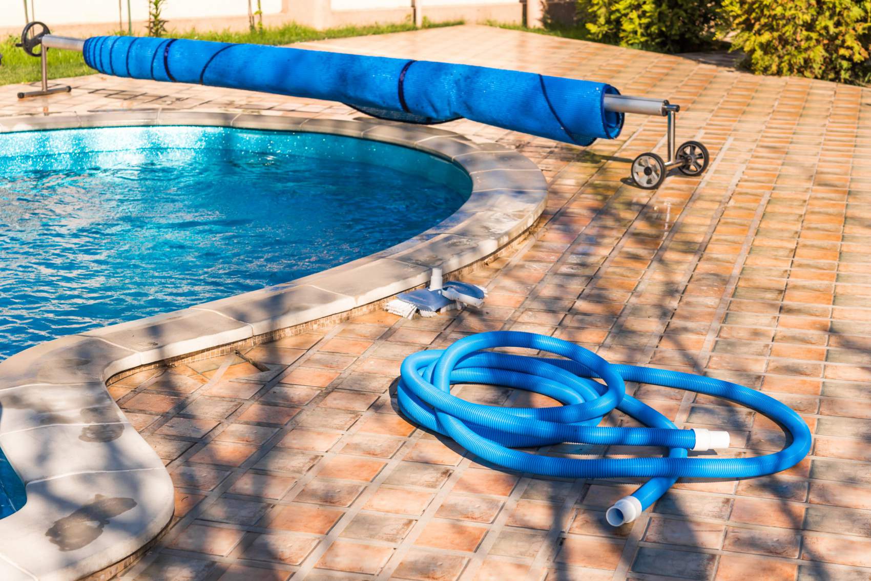 Manual equipment for cleaning pool, brush, hose, swimming pool cover, Yesulskaya, Krasnodar, Russia. Copy space for text