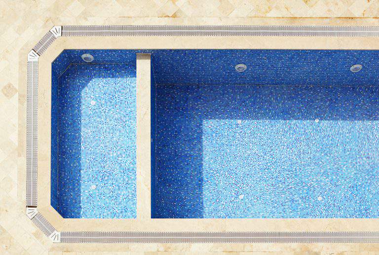 Empty blue tiled swimming pool in a state of disrepair