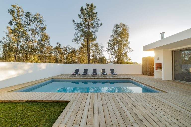 Modern house with garden swimming pool and wooden deck