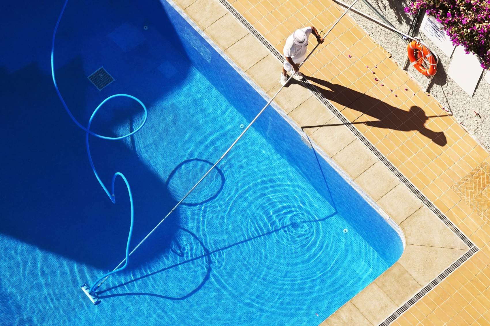 swimming pool cleaning to maintenance by lifeguard worker