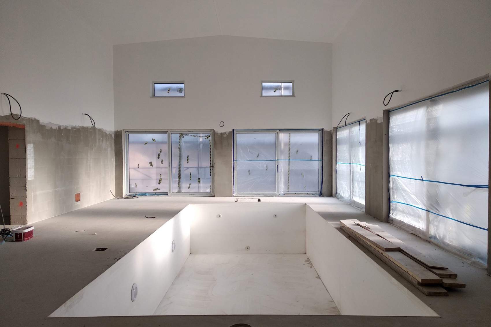 Interior of a house with big swimmig pool under renovation works.
