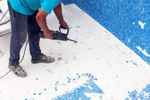 Removing tile in the pool, renovation work of swimming pool